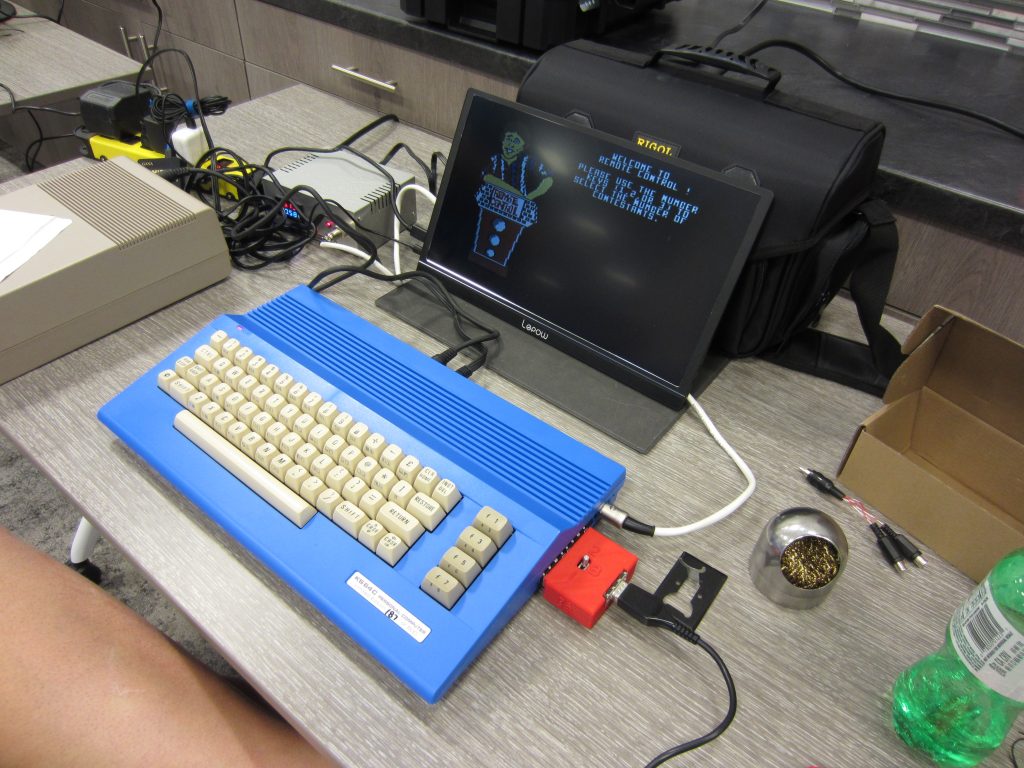 Lige's C64 running the MTV Remote Control trivia game. Note the voltage and amperage meters on the power supply.